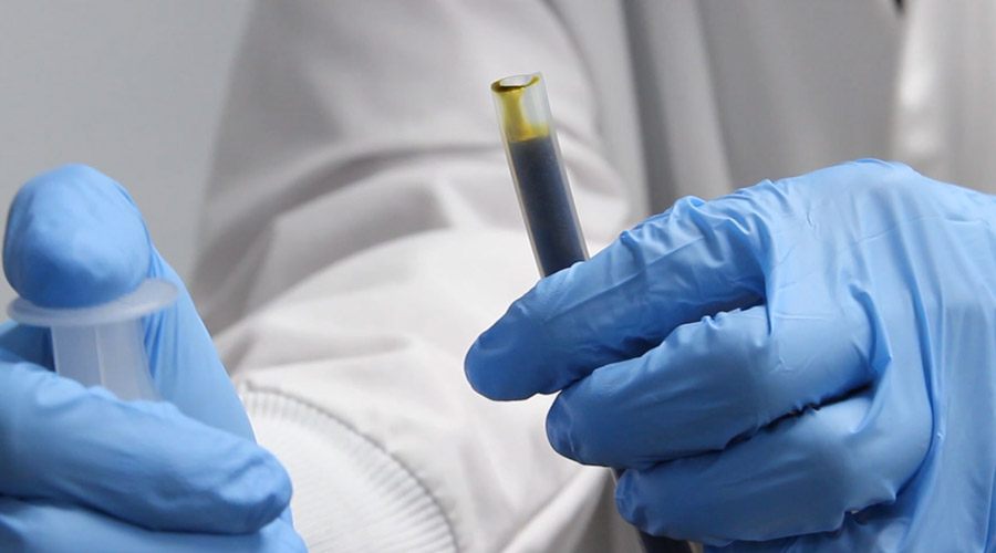 Hemp Extract syringe held by scientist